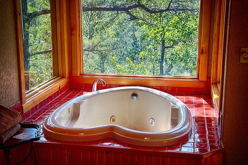 a large jacuzzi tub sitting in front of a window