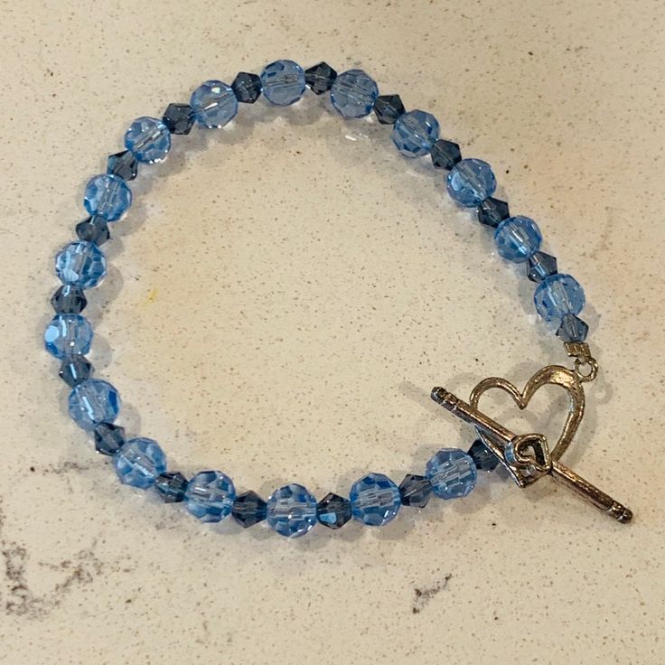 Brand New Beaded Bracelet. Opens With The Heart Clasp. Blue Beaded Bracelets With Heart Beads, Blue Heart-shaped Beaded Bracelets, Blue Beaded Heart Bracelet, Blue Heart-shaped Beaded Bracelet, Blue Heart Bracelet With Round Beads, Blue Heart Beaded Bracelet With Round Beads, Blue Heart And Round Beads Bracelet, Adjustable Blue Heart Bracelet With Round Beads, Adjustable Blue Beaded Bracelet With Heart Charm