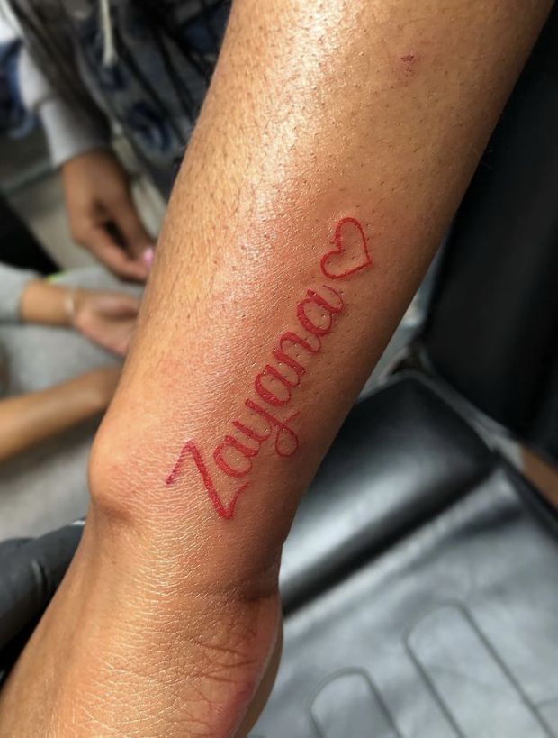 a person with a tattoo on their arm that says, booooooooo