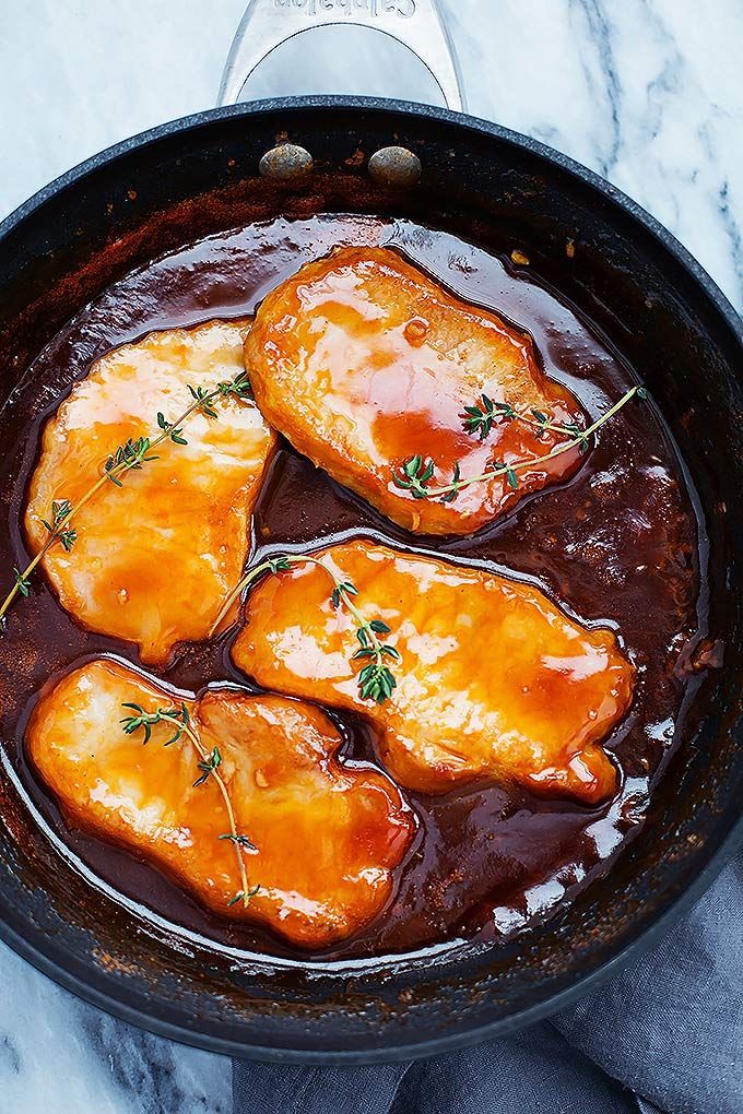 some food is cooking in a skillet on the stove top and ready to be eaten