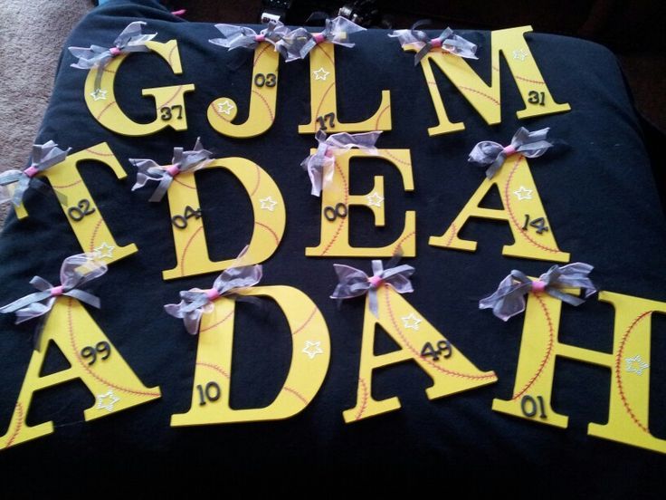 a black pillow with yellow letters and bows on it that says glim idea ah