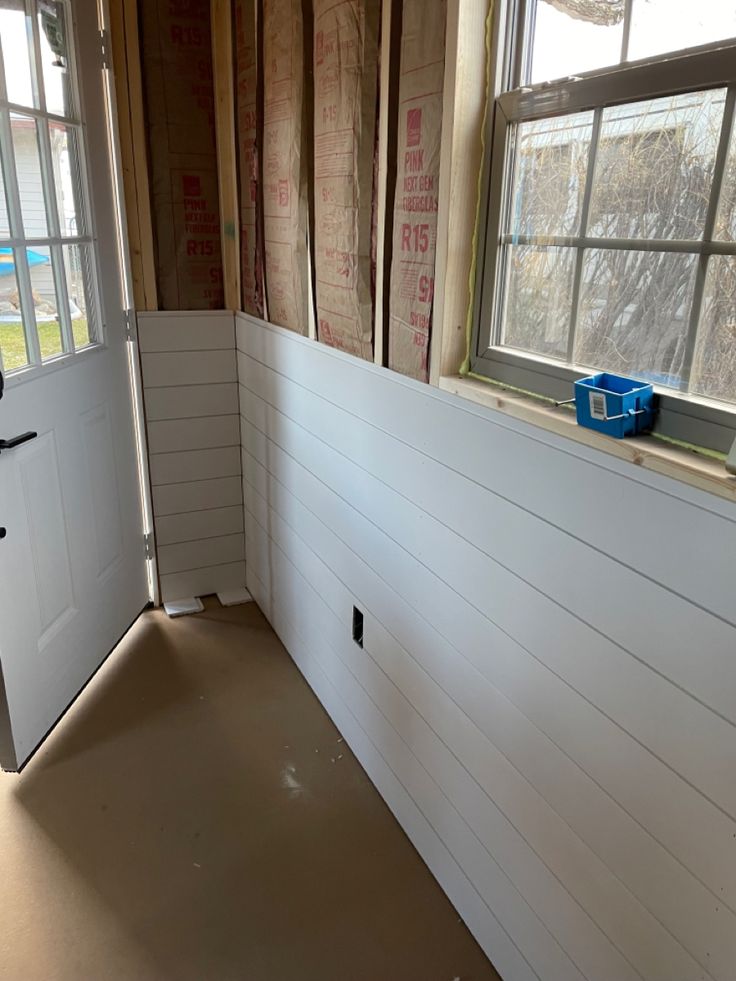 the inside of a house being remodeled with wood framing and walls removed to make room for new windows