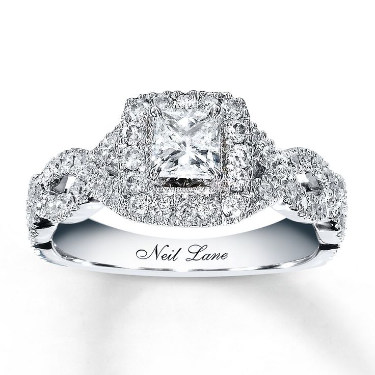 a diamond engagement ring with two rows of diamonds on the band and an inscription that reads,