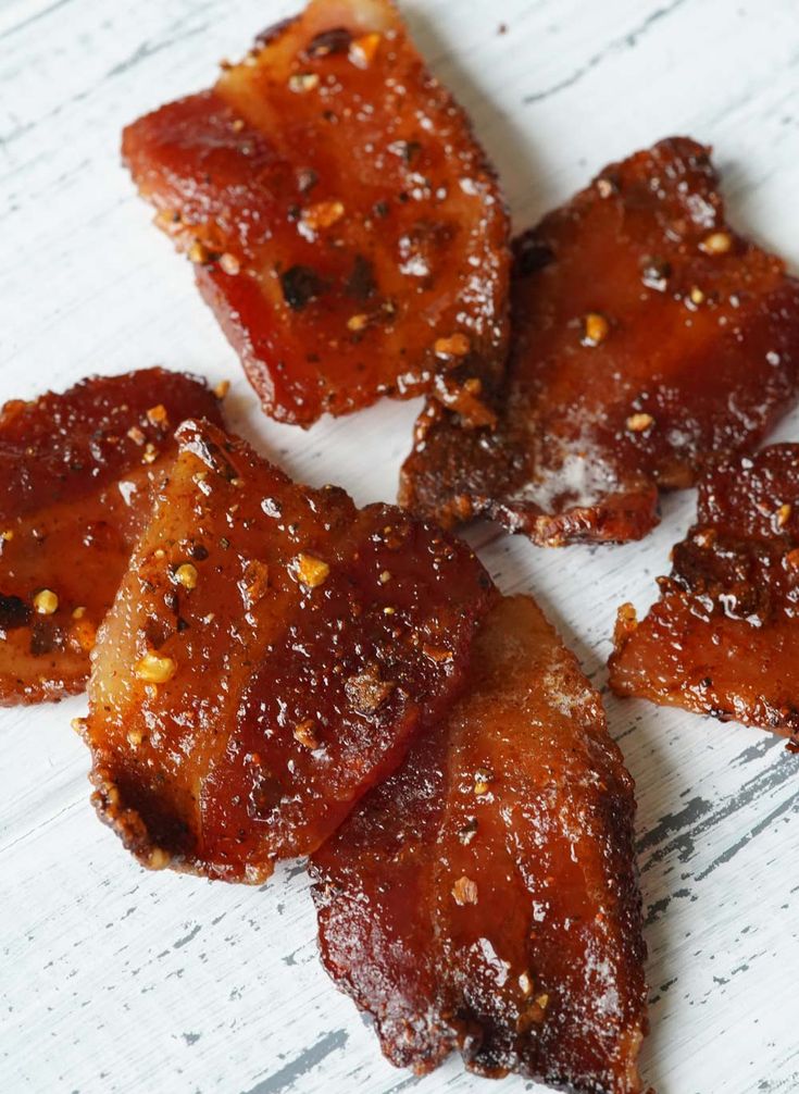 several pieces of bacon sitting on top of a white table