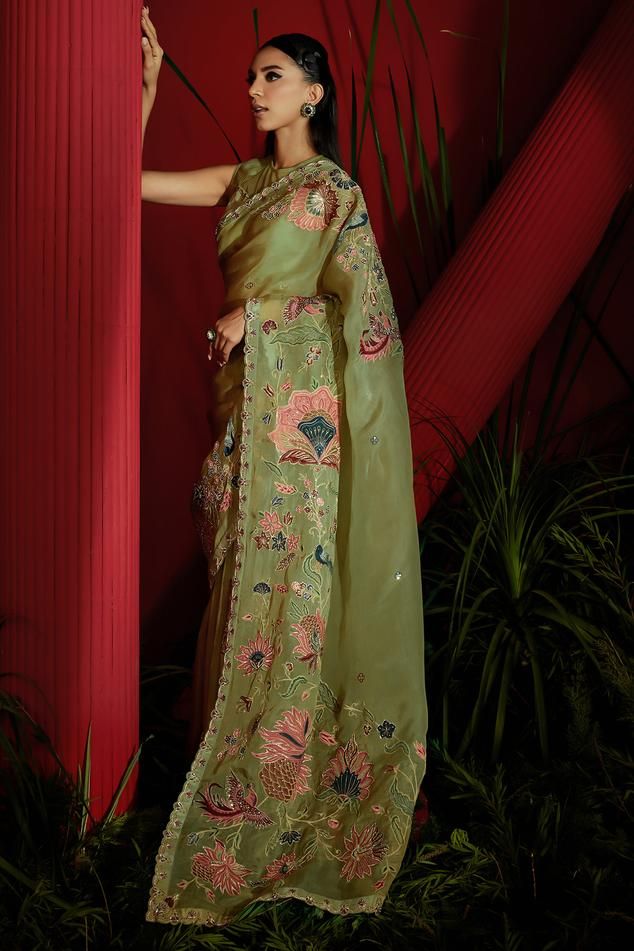 Olive green organza silk saree with hand screen printed buta artwork with embellishments on body and embroidered chintz floral and bird motifs on the pallu embellished with crystals, sequins, beads, dabka and zari. Paired with a matching padded blouse and petticoat. 
Components: 3
Pattern: Embroidered
Type Of Work: Dabka, Zari, Pearl, Sequin
Neckline: Round
Sleeve Type: Sleeveless
Fabric: Silk Organza, Tissue Silk, Soft Net, Nylon Satin, Lining: Heavy Shantoon
Color: Green
Occasion: Mehendi and Green Sleeveless Traditional Wear For Wedding, Sleeveless Green Traditional Wear For Wedding, Sleeveless Green Traditional Wedding Wear, Zari Saree, Organza Silk Saree, Padded Blouse, Bird Motif, Blouse For Women, Silk Organza