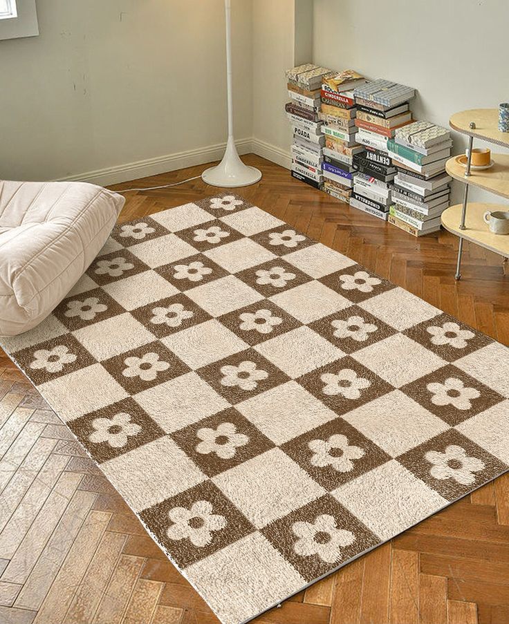 a white and brown rug sitting on top of a wooden floor next to a lamp