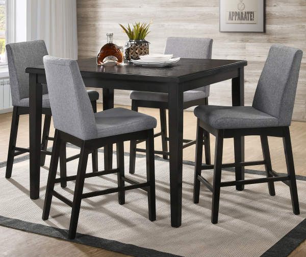 a dining room table with chairs and a rug