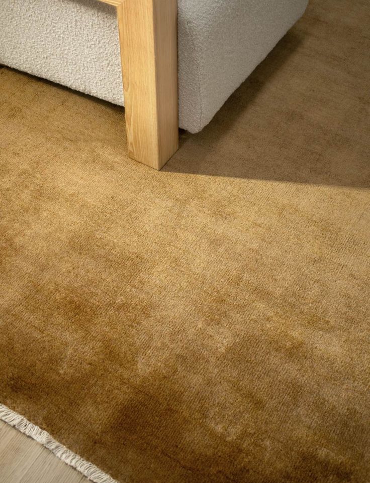 a close up of a bed with a wooden headboard and foot board on the floor