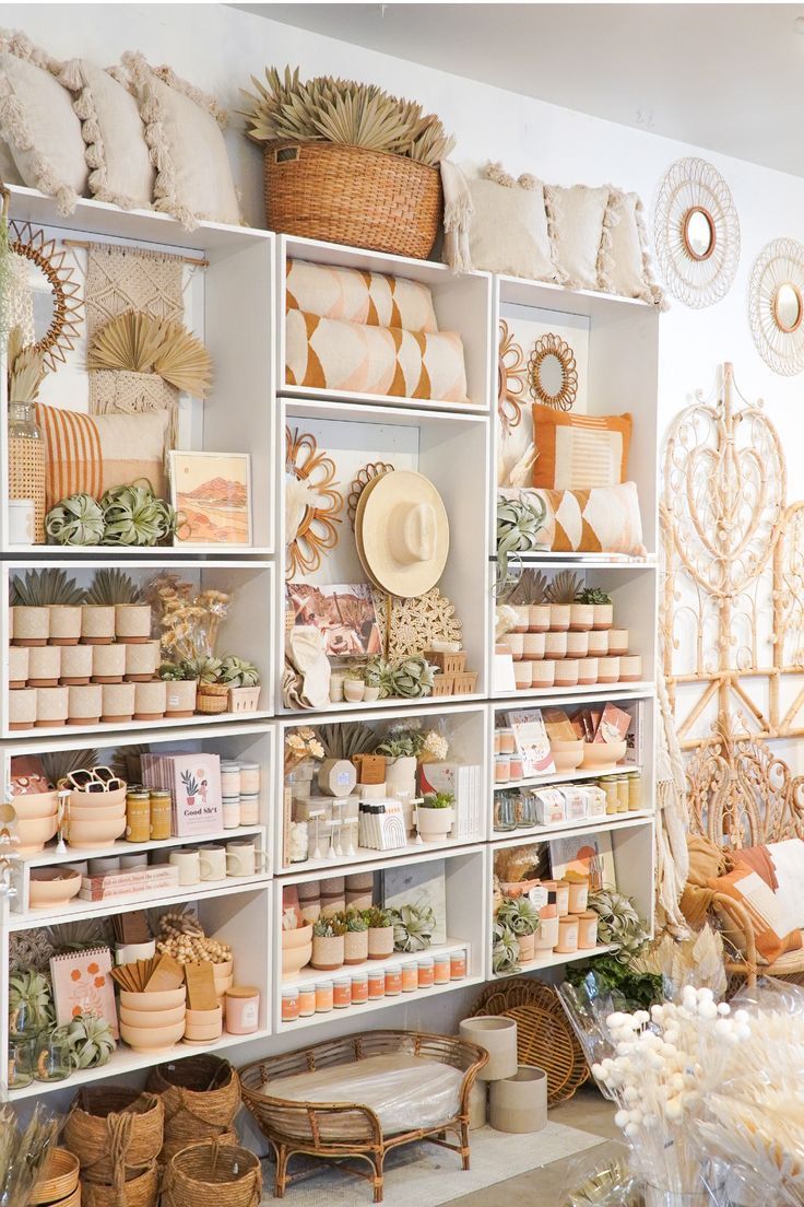 a room filled with lots of different types of baskets and vases on shelving