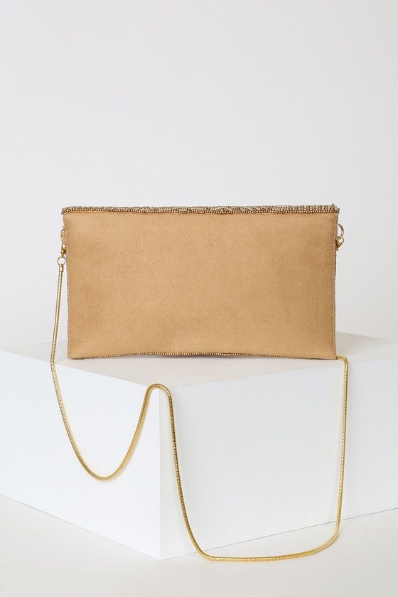 No elegant evening is complete without the Lulus Junipero Gold Beaded Clutch! This chic vegan suede envelope clutch features an eye-catching display of gold beads across a scalloped front flap with magnetic closure. Structured, lined interior features a sidewall pocket perfect for holding all your goodies! Carry as a clutch or attach the matching gold crossbody chain strap. Gold hardware. Lined. Clutch measures 9" wide, 5" tall, and 1" deep (relaxed). 46" detachable gold chain. Glass and plastic Embroidered Clutch Bag, Embroidered Clutch, Gold Clutch, Beaded Clutch, Envelope Clutch, Gold Beads, Magnetic Closure, Chain Strap, Gold Hardware