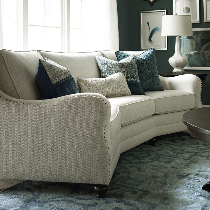 a living room filled with furniture and pillows on top of a blue carpeted floor