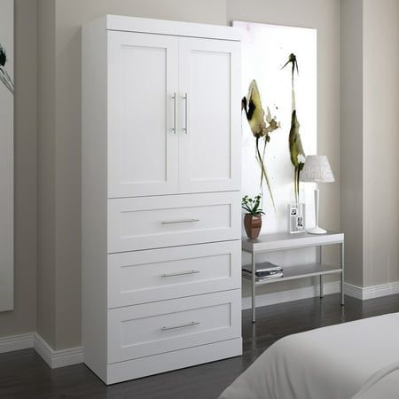 a bedroom with white furniture and large windows