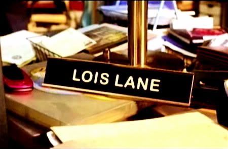 a sign that reads lois lane sitting on top of a table next to other books