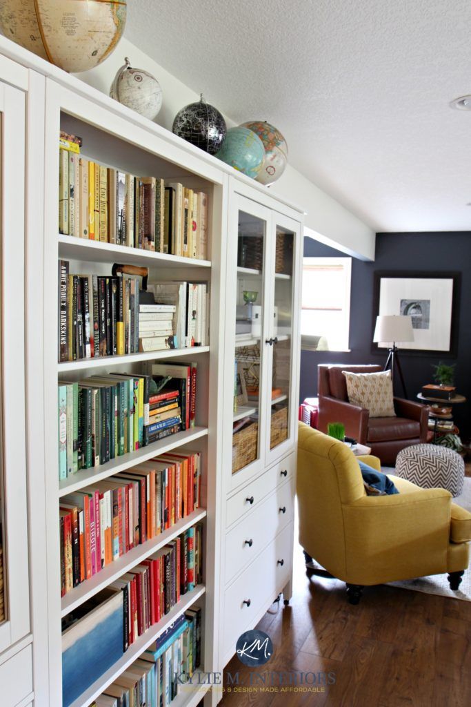 a living room filled with furniture and lots of books