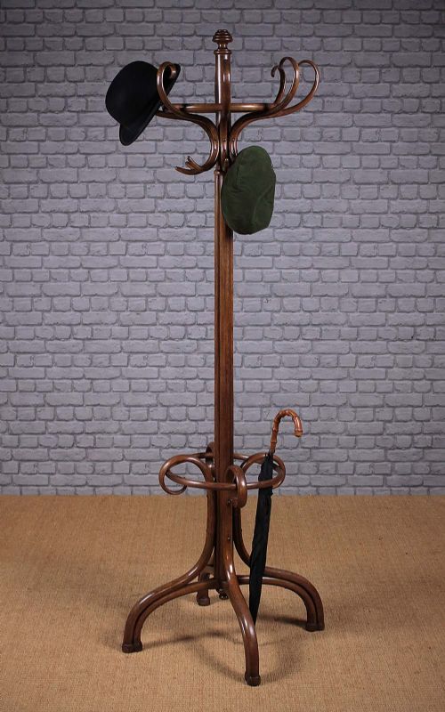 a coat rack with two hats and an umbrella