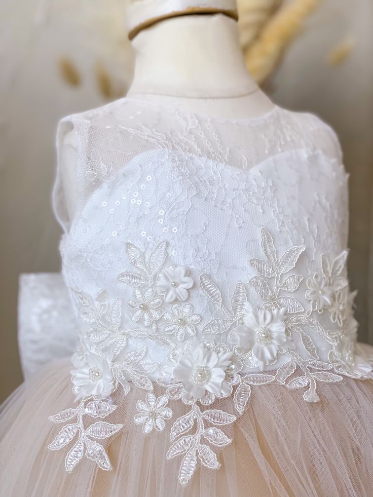 DETAILS: Sweetheart neckline Sheer, lace train Satin bodice with lace overlay 3D floral appliqué at waist Layers of champagne bridal tulle on skirt Matching bow on back Hi-low style Cotton lining Headpiece not included True to size or size up if child is in between sizes Color may vary due to lighting on images PRE ORDER & CUSTOM: Pre orders and custom orders take on average 3-4 weeks to prepare and ship This dress can be custom made up to 12 years Custom orders are Final Sale Please enter the c Lace Princess Dress With Fitted Bodice For Bridesmaids, Tulle Ball Gown With Lace Bodice For Pageants, Cream Lace Ball Gown For Wedding, Elegant Cream Lace Ball Gown, Cream Fitted Princess Dress For Wedding, Lace Ball Gown With Lace Back, Sleeveless Tulle Lace Wedding Dress, Lace Tulle Skirt First Communion Pageant Dress, Lace Tulle First Communion Pageant Dress