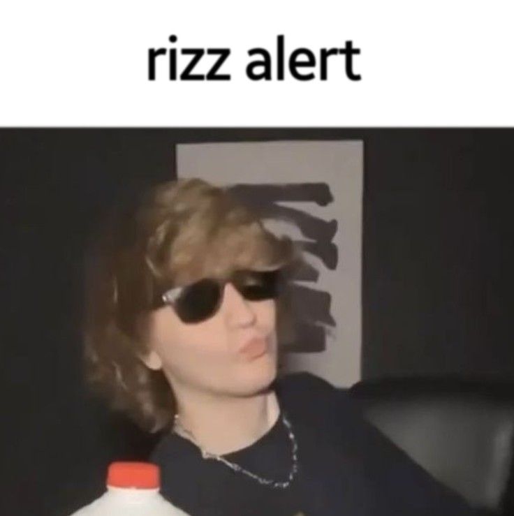 a woman wearing sunglasses and holding a bottle of milk with the caption riz alert