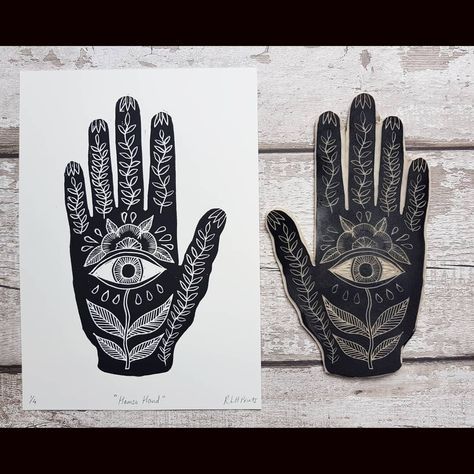 two black and white hand prints with an all seeing eye on the palm, one for each