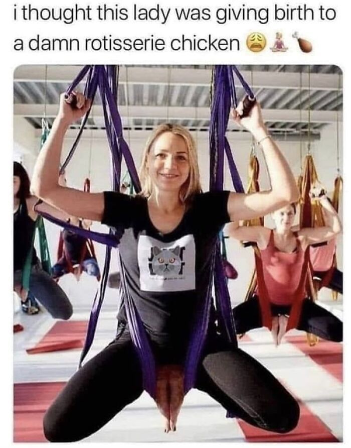 a woman is doing aerial yoga with her hands in the air and smiling at the camera