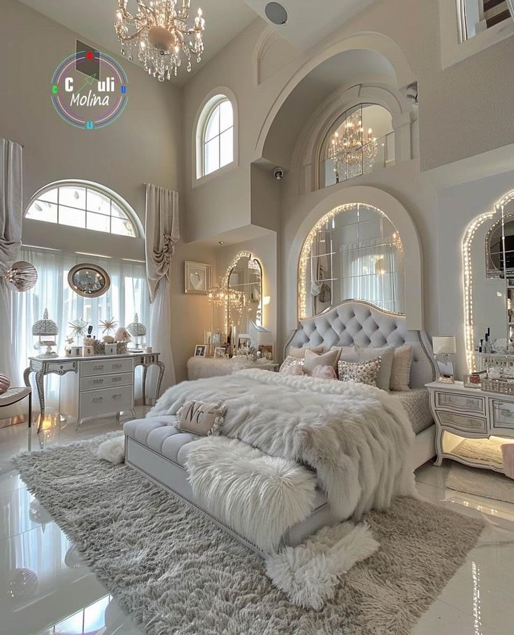 a luxurious bedroom with chandelier and white fur rugs on the floor in front of an arched window