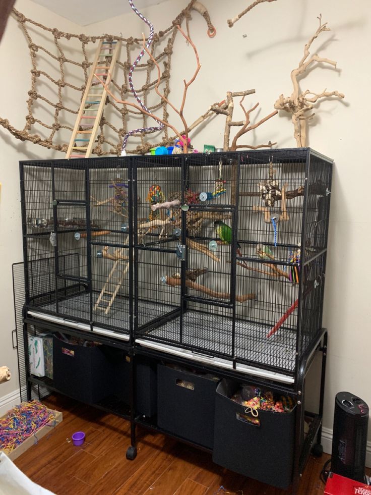 a large bird cage sitting on top of a wooden floor