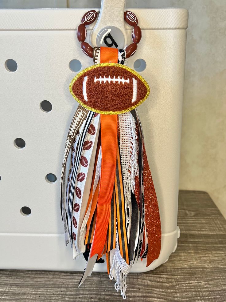 an orange and white purse with a football on it