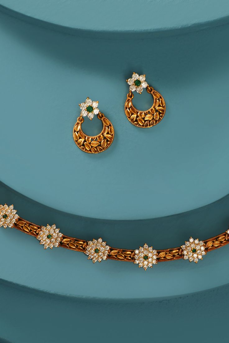 Keep it chic and simple with this antique necklace by Tarinika. Timeless and elegant, the antique-gold tone plated design features a dazzling CZ floral motifs. It is perfect for small events and day occasions, it is a must-have jewelry piece in your box and would make a great gift. Easy to mix and match with other Tarinika antique jewelry collections. Elegant Antique Gold Kundan Necklace, Elegant Kundan Necklace In Antique Gold, Elegant Antique Gold Kundan Necklace With Intricate Design, Elegant Antique Gold Necklaces For Festive Occasions, Elegant Antique Gold Necklace For Festive Occasions, Elegant Antique Gold Kundan Necklace Gift, Elegant Gold Kundan Necklace Made Of Brass, Elegant Gold Kundan Necklace In Brass, Elegant Gold Jeweled Kundan Necklace