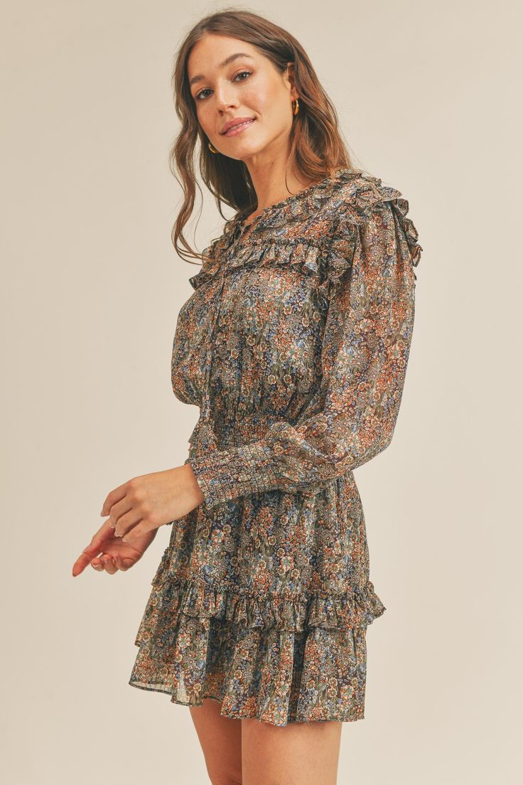 Description Enrich your wardrobe with the elegant Bonnie Dress. Featuring a beautiful brown floral print, this long sleeve dress is both comfortable and chic. The ruffles add feminine details while the smocked waist and cuffs ensure a secure fit. Product Details and Fit - Ties at neckline - Ruffle shoulders and back- Long sleeve dress - Smocking at cuffs- Smocked waistband - Ruffle near hem- Lined - Brown floral print Model Measurements - Model is wearing a size Small Fabric - 100% Polyester, 10 Spring Brown Mini Dress With Ruffle Hem, Fall Floral Mini Dress With Ruffles, Brown Mini Dress With Ruffles And Short Sleeves, Brown Floral Print Puff Sleeve Dress, Bohemian A-line Mini Dress With Ruffles, Brown Floral Print, Print Models, Brown Floral, Smock Dress