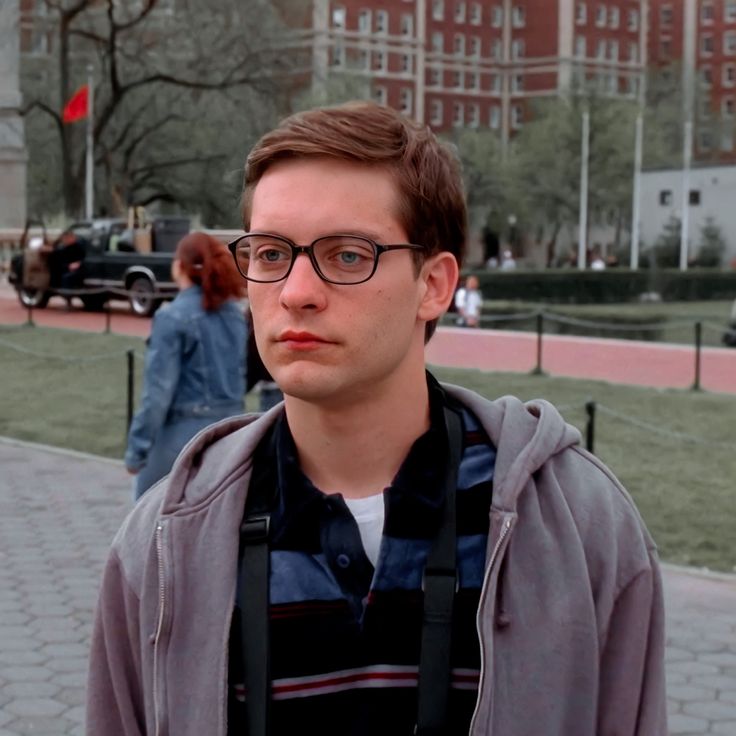 a young man with glasses and a backpack