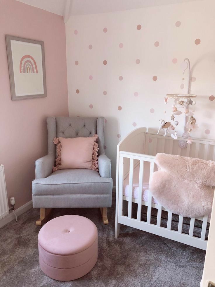 a baby's room with pink and gray furniture, polka dots on the wall