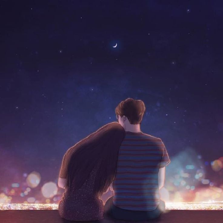 two people sitting on a ledge looking at the night sky with lights in the background