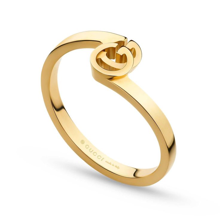 From Gucci, this GG Running ring is crafted in 18k yellow gold and features a design inspired by vintage Gucci logo designs. Boasting a bypass silhouette, this ring showcases a GG logo in the center. The band measures 0.75 inches in width and the GG motif is 0.3 inches in width and 0.20 inches in height. Made in Italy. This ring is a size 6.75. Gucci Style #: YBC457122002014 Top Jewelry Trends, Yellow Gold Stacking Rings, Gucci Yellow, G Ring, Fine Gold Jewelry, Long Pearl Necklaces, Gucci Jewelry, Stack Ring, Bar Stud Earrings