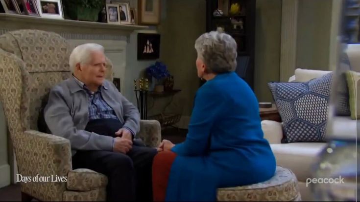 an older man and woman sitting in chairs talking