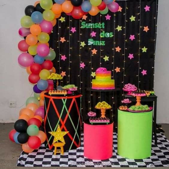 a birthday party with balloons, cake and decorations