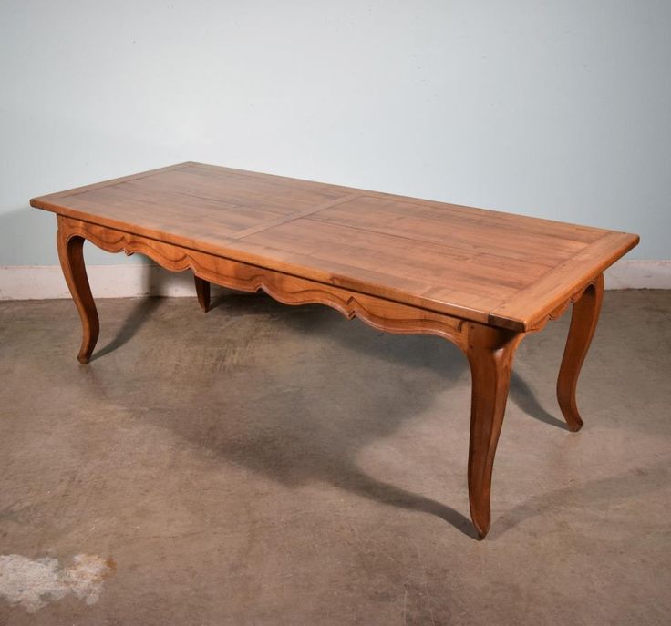 a wooden table sitting on top of a cement floor