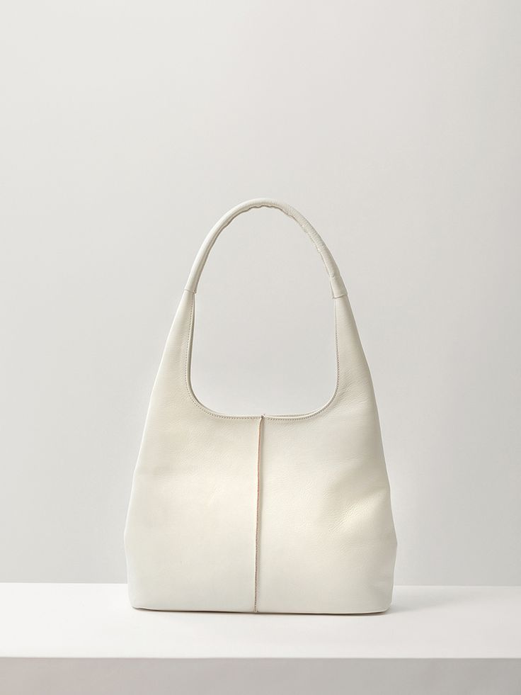 Editor's NoteAUTT is a bag and accessory brand that pursues natural beauty with restrained detail design based on minimalism.- Minimal hobo bag with a curved silhouette- The stitch line on the front adds a rough feel- Made of flexible and soft high-quality vegetable leather- Featured a subtle gloss and soft touch as you use it- The top can be closed with a hidden magnet- Harmonized with the natural leather texture and flowing body shapeMeasurements (in.)- Size: 13.39 in. * 10.04 in.- Strap: 10.6 Korean Fashion Bag, Minimal Bags, Bright Outfits, Slouch Bags, Vegetable Leather, Detail Design, Girly Bags, Stitch Lines, W Concept