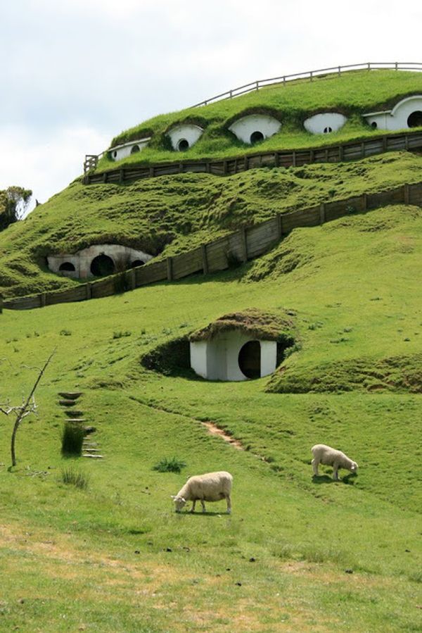 an area with grass covered mounds on the top and small holes in the ground at the bottom