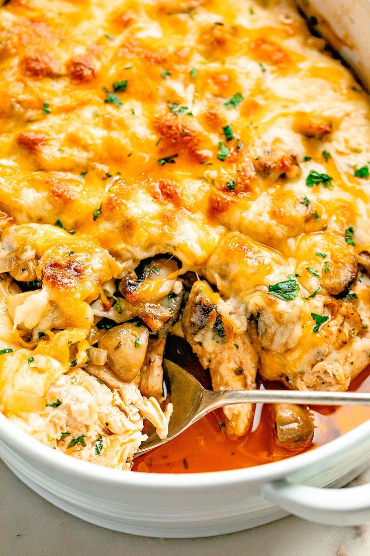 a casserole dish filled with chicken and cheese