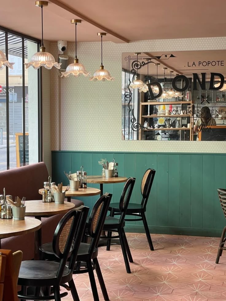 the inside of a restaurant with tables and chairs