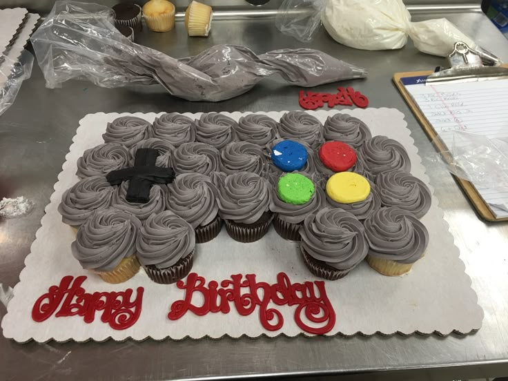 a birthday cake with cupcakes on it