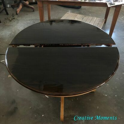 a black table sitting on top of a hard wood floor