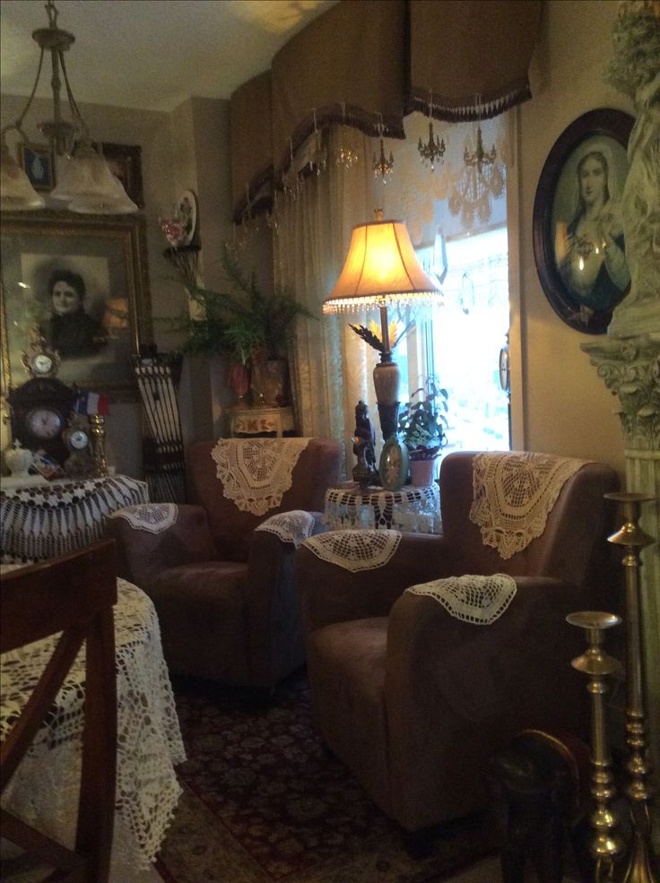 a living room filled with lots of furniture next to a tall clock on the wall