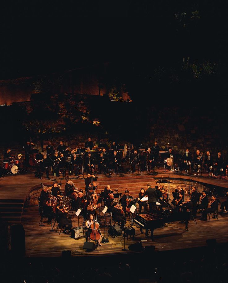 an orchestra performing on stage at night