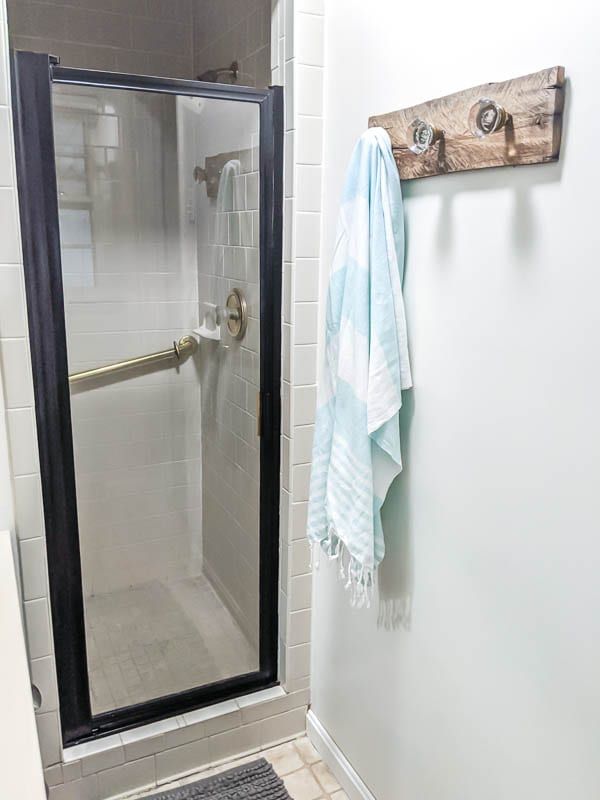 a towel hanging on the wall next to a shower