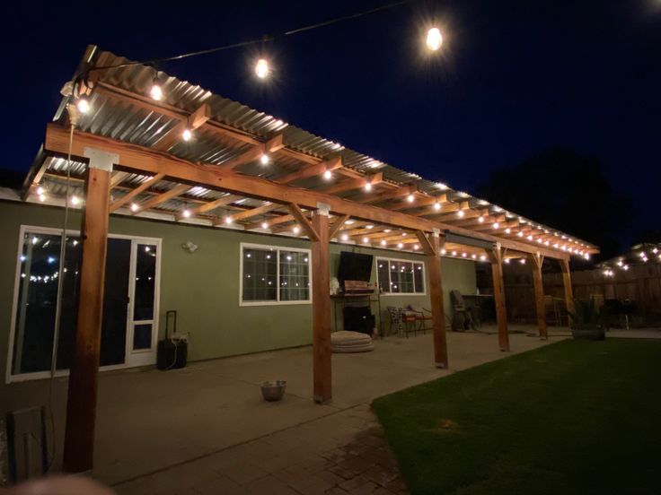 an outdoor covered patio with string lights