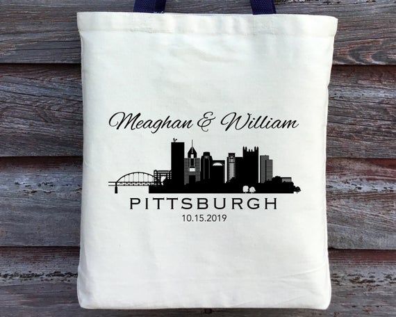 a tote bag with the name and image of a city in black on it