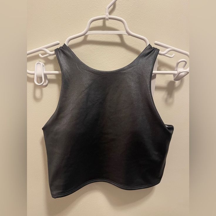 Nwt Shiny Black Crop Top Fits A-C Cup. Chest: 14” Length: 15.5” Sleek Black Club Top, Black Fitted Tank Top For Club, Fitted Black Tank Top For Club, Trendy Black Crop Top For Workout, Sleek Black Crop Top For Night Out, Sleek Black Cropped Top, Black Stretch Cropped Tank Top, Fitted Racerback Top For Club, Black Fitted Athleisure Crop Top