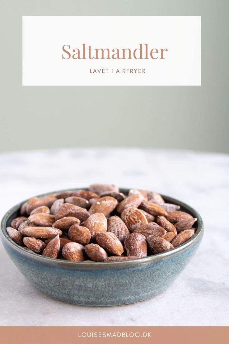 a bowl filled with almonds sitting on top of a table