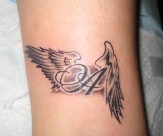 a tattoo on the arm of a woman with an angel wing and letter s in it