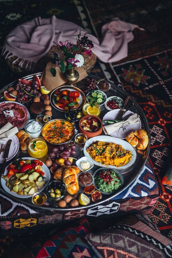 a platter full of food sitting on top of a rug